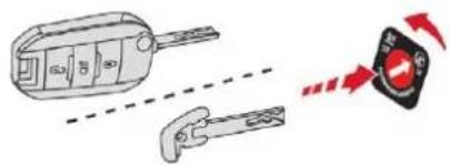 Diagram showing a car key with labeled parts and a warning sign indicating alert or hazard.