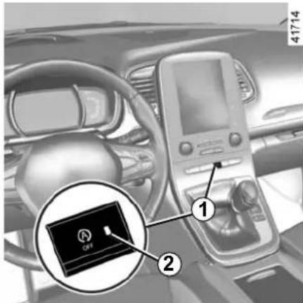 Car interior view with labeled diagnostic device and numbered component, showing dashboard and steering wheel