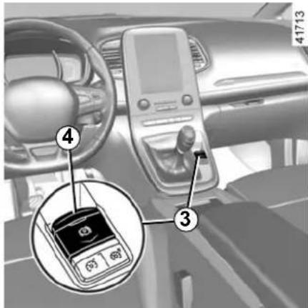 Interior view of a car dashboard with labeled parts including a mobile phone and a keypad, showing numbered annotations.