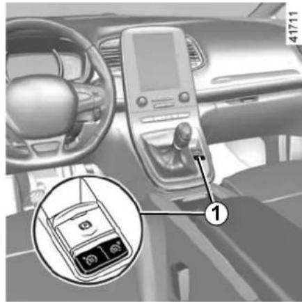 Car interior view with digital dashboard, steering wheel, and a close-up of the phone's screen showing 60s and 65s.