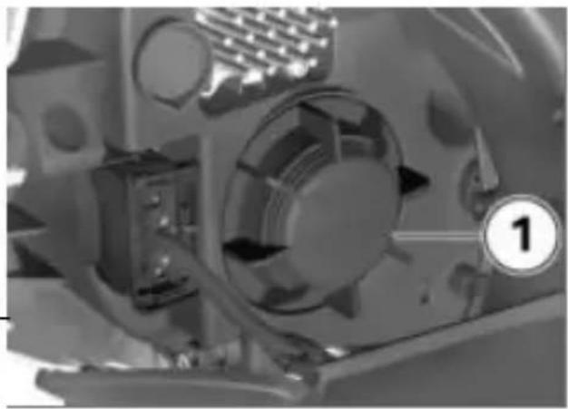 Close-up of a mechanical component with visible gears and a numbered label (1), no readable text or symbols present.