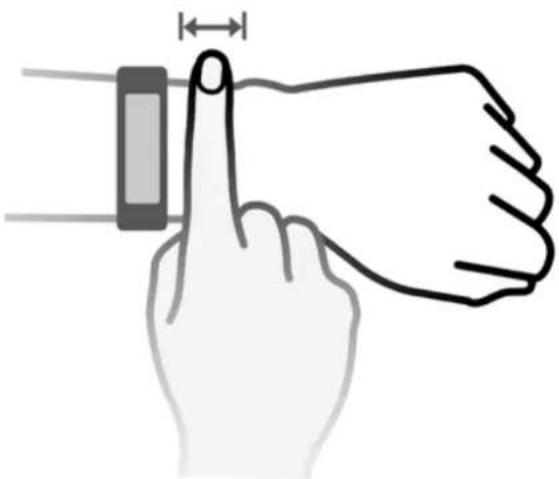 Diagram showing finger positioning on a device with measurement annotation