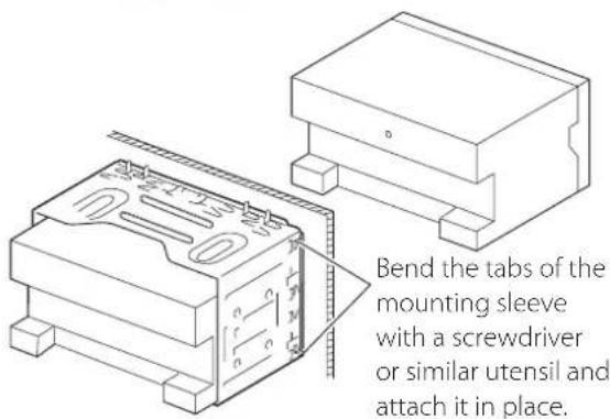 Bend the tabs of the mounting sleeve with a screwdriver or similar utensil and attach it in place.
