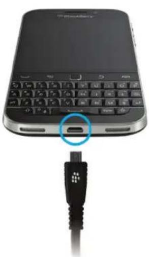 Close-up of a black USB cable inserted into the smartphone keyboard, showing the connector (no text or symbols visible)