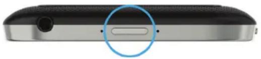 Close-up of a black electronic device showing a button and screen (no text or symbols visible)