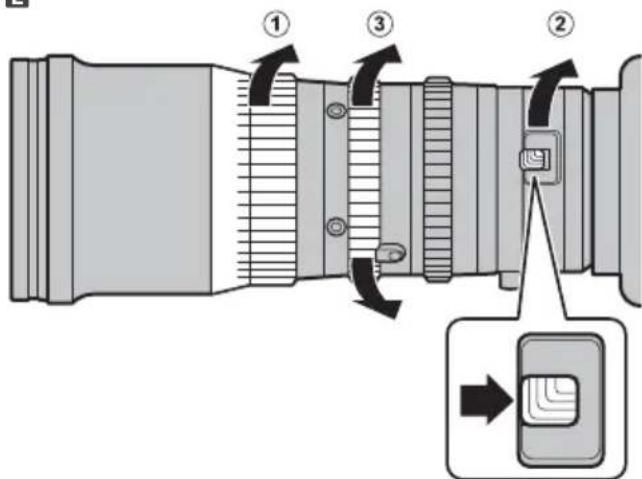 Diagram of a camera lens with labeled parts and directional arrows indicating motion or assembly steps