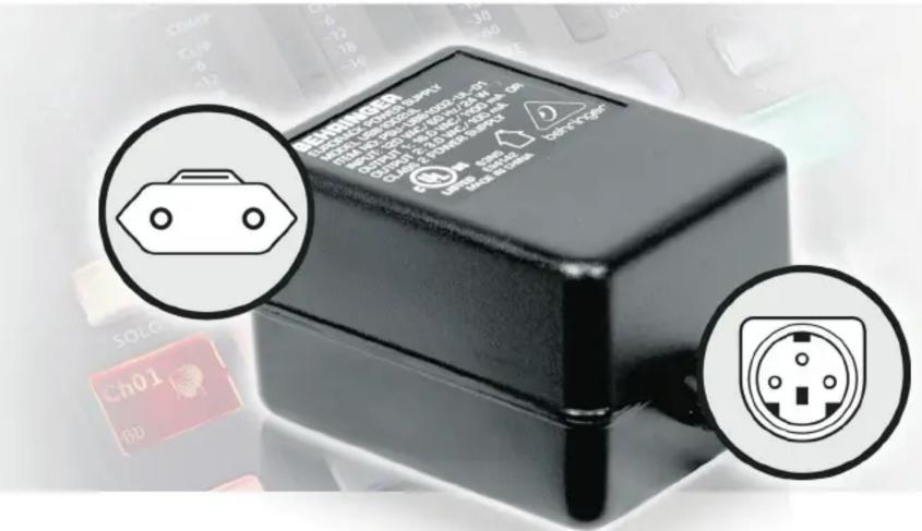 Close-up of a black electronic device with warning labels and two circular insets showing electrical plug symbols.