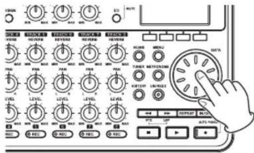 Diagram of an audio or electronic device control panel with labeled knobs, switches, and a hand pointing to a rotary dial.
