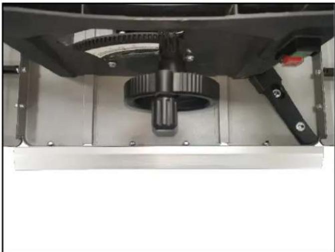 Close-up of a mechanical assembly with a central gear and mounting bracket (no visible text or symbols)