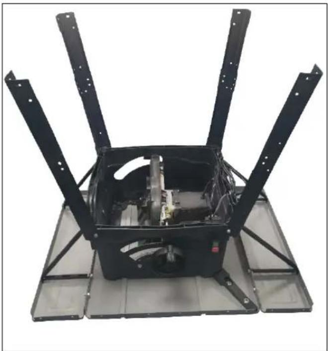 Exterior view of a black industrial fan or motor assembly with four vertical metal rods and a central housing (no text or symbols visible)