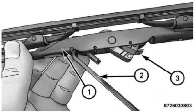 Technical diagram showing a hand holding a mechanical device with numbered annotations pointing to different parts.