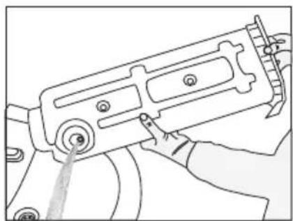 Line drawing of a hand operating a mechanical device with no visible text or symbols