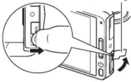 CASIO EX-TR1250 - Greifen Sie mit dem Fingernagel in die Nut der USB-Port-Abdeckung und ziehen Sie die Abdeckung in Pfeilrichtung auf. - 1