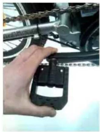 Close-up of a hand holding a bicycle brake component, no visible text or symbols