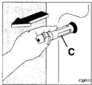 Diagram showing a hand holding a tool with labeled component 'C' and a wall-mounted device, likely illustrating a mechanical or electrical setup.