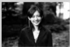 Black-and-white portrait of a smiling woman in formal attire (no visible text or symbols)