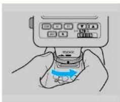 Illustration of hands using a handheld device to press or install a device (no text or symbols visible)