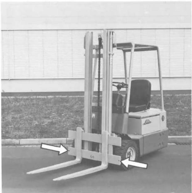 Linde E15 S - Zinkensicherung an Gabelträger (Pfeile) - 1