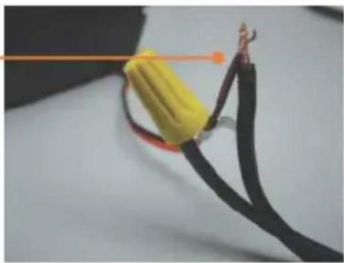 Close-up of a black cable with yellow insulation and red strap, connected by wires (no text or symbols visible)