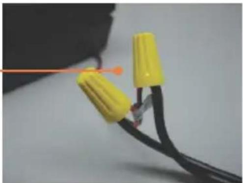 Close-up of yellow connectors with black wires and orange wires, no visible text or symbols
