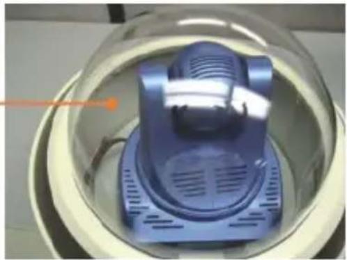 Close-up of a blue industrial vacuum cleaner inside a transparent dome (no visible text or symbols)
