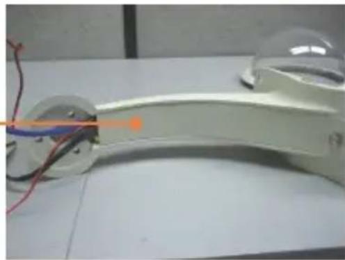 Close-up of a white mechanical device with wires and colored probes, no visible text or symbols