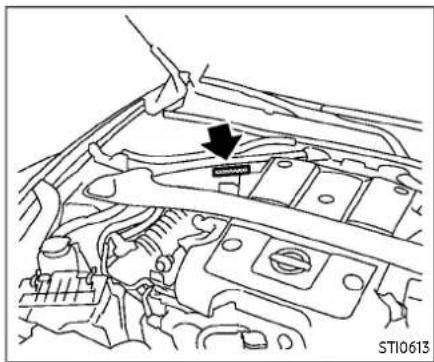 Technical line drawing of a car engine bay with a hand adjusting the component (no text or symbols visible)