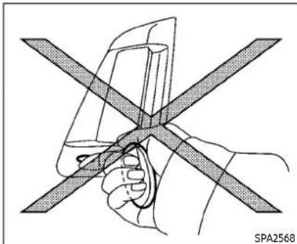 Diagram of a hand holding a device with intersecting diagonal bands, no text or symbols present