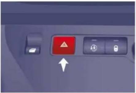 Close-up of a vehicle control panel with a red warning sign and directional arrow indicator