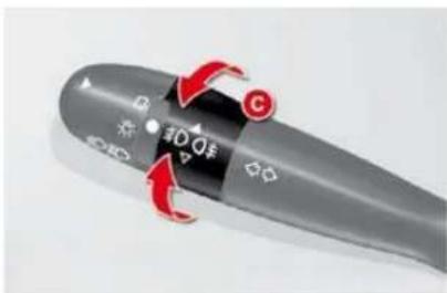 Close-up of a gray remote control knob with red arrows indicating clockwise rotation and 'C' label, showing function buttons and display.