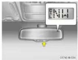 Diagram showing a car interior with a digital display and directional arrow, likely indicating navigation or movement.