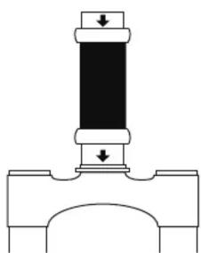 Pure mechanical diagram showing a piston or spring assembly with downward force arrows (no text or symbols)