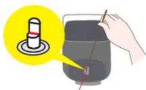 Illustration showing a hand using a pen to test a test tube with a magnified view of the tube's tip.