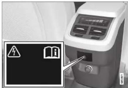 Medical device photo with warning sign and warning symbol icons, including a warning triangle and an open book icon