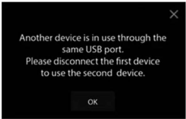 Another device is in use through the same USB port. Please disconnect the first device to use the second device.