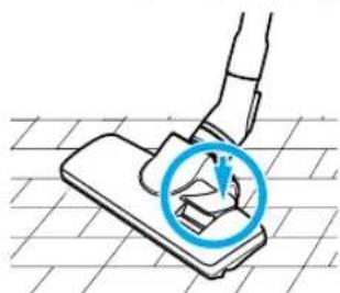 Diagramm einer Hand, die mit einem Werkzeug ein Bauteil auf einem Fliesenboden drückt oder installiert, mit einem blauen Kreis, der das Bauteil hervorhebt (kein Text oder Symbole vorhanden)