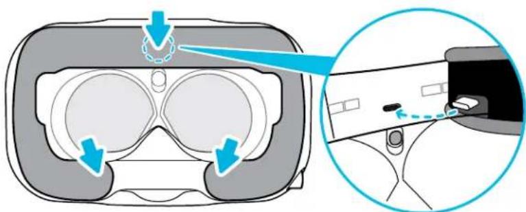 Diagram illustrating VR headset components with blue arrows indicating motion or movement, including a magnified inset showing a device's interior and control panel.