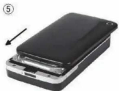Stacked black electronic device with a white connector, showing internal components and an arrow indicating assembly (no text or symbols visible)