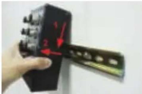 Hand holding a device with red arrows pointing to numbered components, likely indicating measurement or assembly steps.