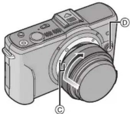 PANASONIC Lumix DMC-GF2W - Richten Sie die roten Markierungen © an Kameragehäuse und Objektiv aneinander aus und drehen Sie das Objektiv in Pfeilrichtung, bis es hörbar einrastet. - 1