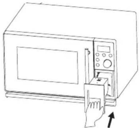Line drawing of a microwave oven with a hand inserting a paper into the door (no text or symbols)