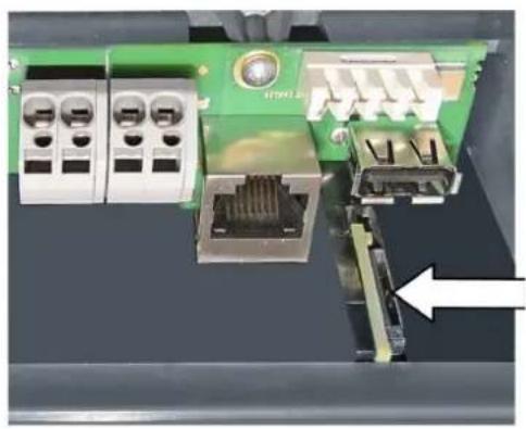Close-up of an electronic circuit board with connectors and a white arrow pointing to a component (no visible text or symbols)