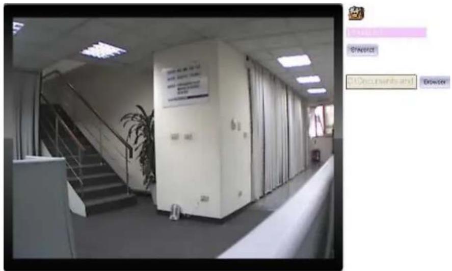 Black-and-white photo of an office hallway with visible server racks and a wall-mounted display board containing text.