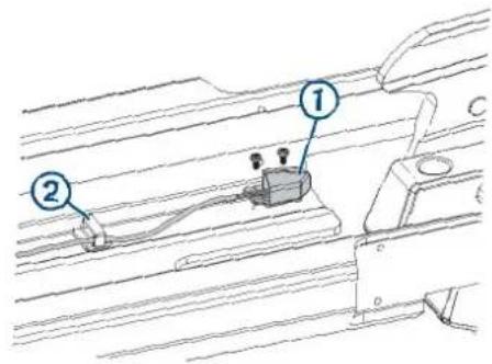 Technical diagram showing two labeled components (1 and 2) on a mechanical or electrical assembly with wires and connectors.