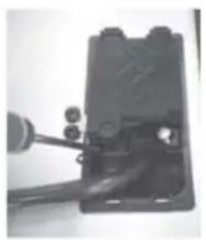Close-up of a mechanical component with a lever and attached parts (no visible text or symbols)