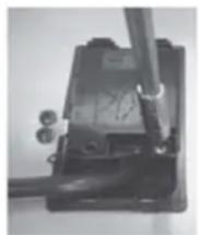 Close-up of a mechanical device with a lever and base, no visible text or symbols
