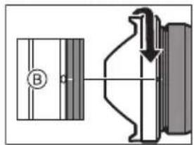 Technical diagram showing a mechanical assembly with labeled component B and directional arrow indicating motion or force