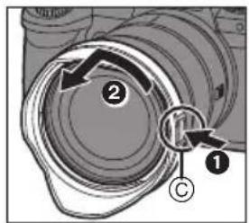 Technical diagram showing a camera lens assembly with labeled parts and directional arrows indicating motion or movement.