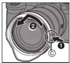 Technical diagram showing a camera lens assembly with labeled parts and directional arrows indicating motion or movement.