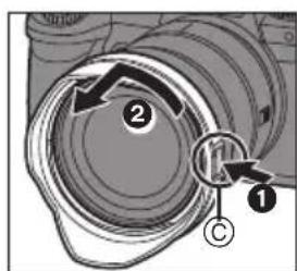 Diagram showing a camera lens assembly with labeled parts and directional arrows indicating motion or movement.